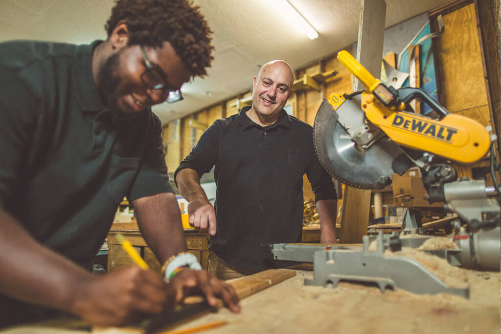 Two men working with power tools